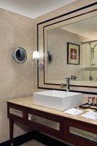 a bathroom with a sink and a large mirror at Sheraton Grand Pune Bund Garden Hotel in Pune