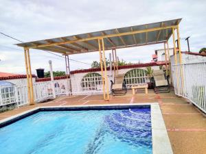 a swimming pool with a pergola on a house at Casa campestre arbelaez in Arbeláez +9 photos