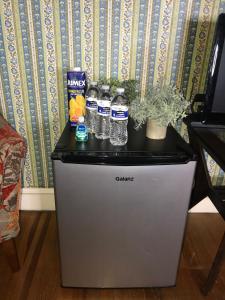 a small refrigerator with water bottles on top of it at Pacifico’s Place “2C” in Hartford