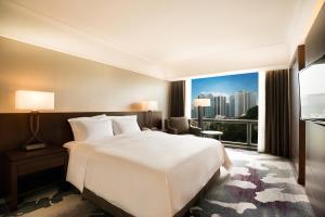 a hotel room with a bed and a television at Millennium Hilton Seoul in Seoul