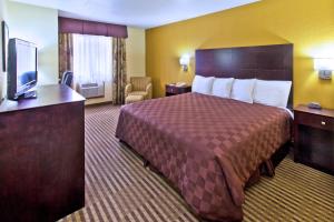 a hotel room with a bed and a flat screen tv at Quality Inn in Council Bluffs