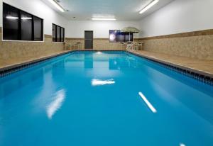 a swimming pool with blue water in a hotel room at Quality Inn in Council Bluffs