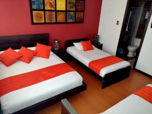 Postel nebo postele na pokoji v ubytování Hotel Fidenzi Bogotá