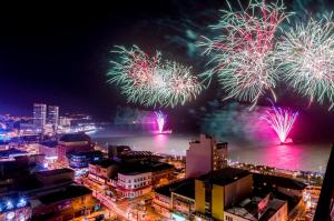 a view of fireworks over a city at night at Hotel Gran Pacifico in Puerto Montt
