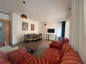 a living room with a couch and a table at Casa Rural Cascadas del Hueznar in San Nicolás del Puerto