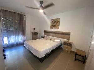 a bedroom with a bed and a ceiling fan at Casa Rural Cascadas del Hueznar in San Nicolás del Puerto +15 photos