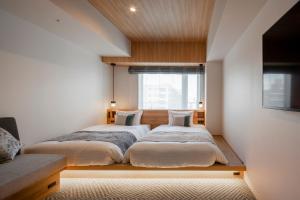 Tokyu Stay Shinjuku Eastside tesisinde bir odada yatak veya yataklar