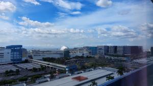 a view of a city with buildings and the ocean at MSH property Sea Residences MOA Pasay City by Queennie in Manila