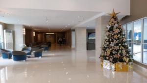 a christmas tree in the middle of a lobby at MSH property Sea Residences MOA Pasay City by Queennie in Manila