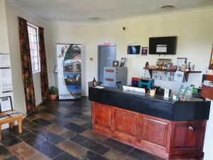 a bar in a room with a tiled floor at McNevins Warwick Motel in Warwick