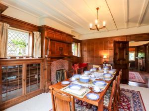 a dining room with a long table with chairs at Yellow House on the Corner in Frinton-on-Sea