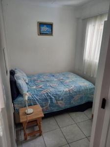 a bedroom with a bed and a table with a lamp at Sunset Beach 34 in Margate