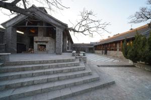 a brick building with stairs in front of it at 7Shang长城大宅 in Huairou