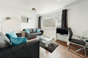 a living room with a couch and a table at Arlan Apartments Comfort and Ease, Hinckley in Hinckley