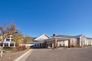 a large building with a road in front of it at AmericInn by Wyndham Fort Pierre Conference Center in Fort Pierre