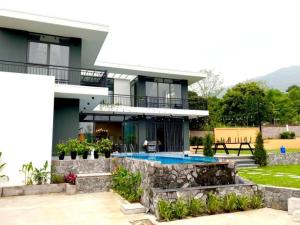 a house with a swimming pool in front of it at Sun Hill Villa Ba Vì - Venuestay in Hanoi