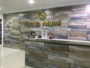 a sign for a china motel on a wall at The Dhania Cenang Beach Langkawi in Pantai Cenang +42 photos