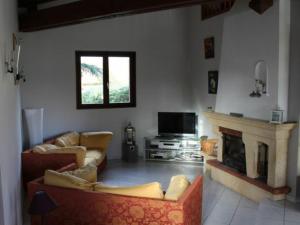 a living room with two couches and a fireplace at Gîte Bénaménil, 5 pièces, 6 personnes - FR-1-584-4 