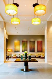 a lobby with a waiting room with tables and chairs at The Westin Bellevue in Bellevue