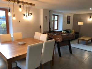 a dining room with a table and a ping pong ball at L'apparté, 83m² pour s'évader en famille ou à deux in Gérardmer