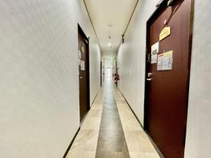 a hallway with a long corridor with at Time Rich in Okinawa City