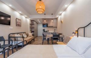 a room with two beds and a living room at New Gudauri Neo Apartment 306 in Gudauri
