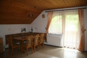 a dining room with a table and chairs and a window at Guest House Kveder in Škofja Loka