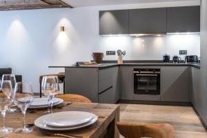 a kitchen and dining room with a table and chairs at Alaska Lodge by Alpine Residences in Val dʼIsère