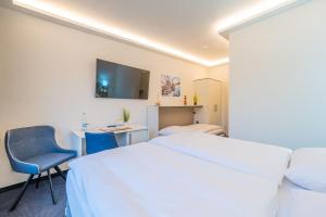 Ένα ή περισσότερα κρεβάτια σε δωμάτιο στο Hotel Mukran
