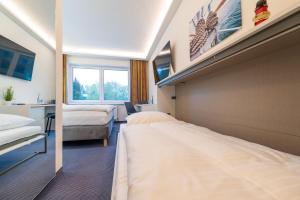 Ένα ή περισσότερα κρεβάτια σε δωμάτιο στο Hotel Mukran
