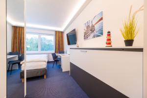 Ένα ή περισσότερα κρεβάτια σε δωμάτιο στο Hotel Mukran