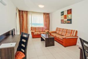 a living room with two couches and a table at Hermes Club Hotel - Ultra All Inclusive in Tsarevo