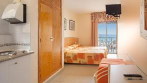 a bedroom with a bed and a view of the ocean at Estudios RH Sol in Benidorm
