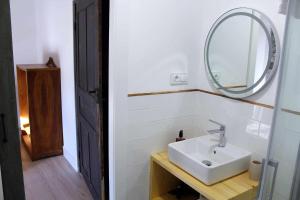 a bathroom with a sink and a mirror at Casa Rural Estrella del Sil in Corbón del Sil +31 photos