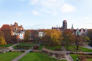 a view of a park with a city in the background at Elite Apartments Old Town Center Premium in Gdańsk