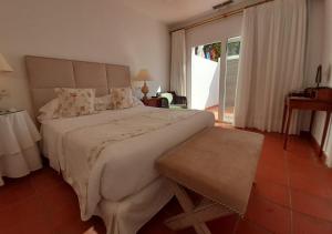 a bedroom with a large bed and a large window at miKasa Agua Amarga & SPA in Agua Amarga