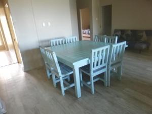 a dining room table with four chairs and a blue table and chairsktop at Portofino Unit 22 in Margate