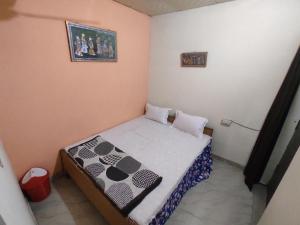 a small room with a small bed in it at Superinn home stay& guest house in Agra