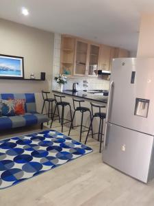 a living room with a refrigerator and a kitchen at Portofino Unit 22 in Margate