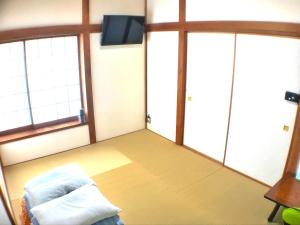 a room with two windows and a bed and a tv at YADO OMIYA / Vacation STAY 45672 in Kamogawa