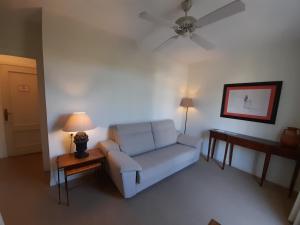 a living room with a couch and a ceiling fan at miKasa Agua Amarga & SPA in Agua Amarga