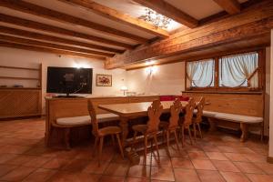 uma sala de jantar com mesa e cadeiras em Casa Belvedere 1 em San Vito di Cadore