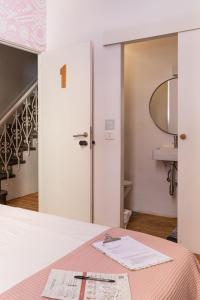 a room with a bed with a mirror and a sink at Mapango Small Rooms in Santa Cruz de Tenerife