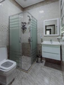 a bathroom with a shower and a toilet and a sink at Mehsul Recreational Center in İsmayıllı