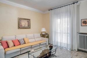a living room with a couch and a large window at Sentirsi a casa, lontano da casa-feel at home away from home in Caronno Pertusella