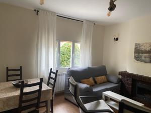 a living room with a couch and a table at EL CHALET in Rascafría