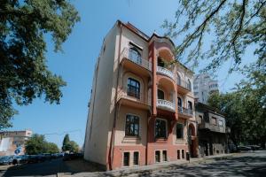a tall orange building on the side of a street at BlueSky Ultra-Central Premium Apartment in Oradea