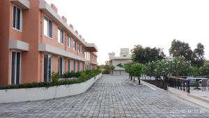 a cobblestone street in front of a building at juSTa Rudra Resort & Spa in Kolād