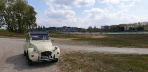 an old white truck parked on a dirt road at Gite Renaissance in Amboise