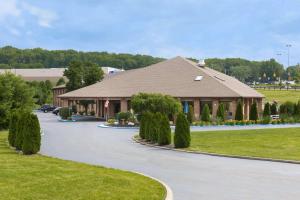 a large building with a driveway in front of it at Baymont by Wyndham Lancaster in Lancaster